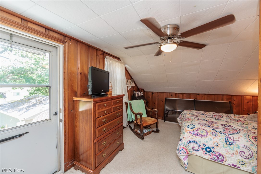 5364 Summit Road Lyndhurst, OH 44124 - Photo 15 of 42 Room featuring wood paneling, sloped ceiling, and a ceiling fan with integrated lighting