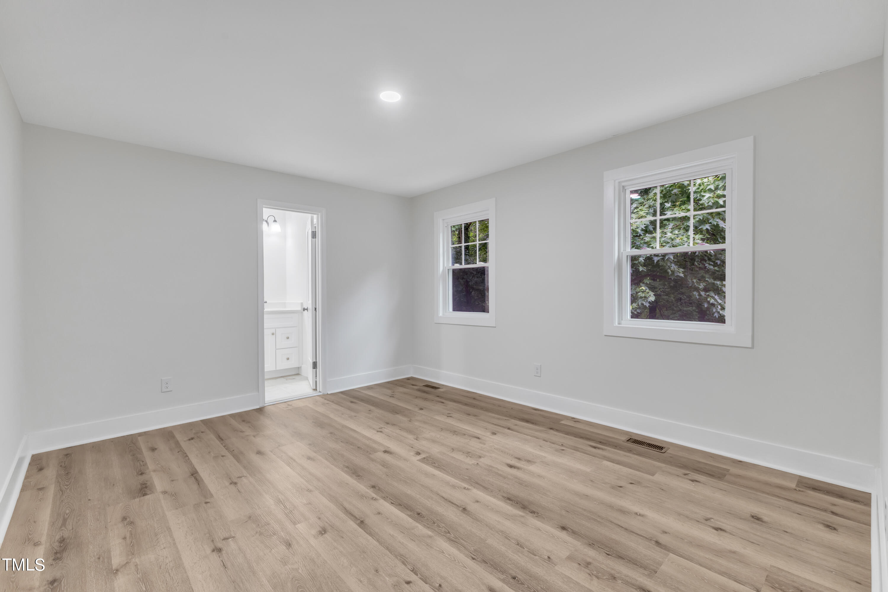 Undisclosed Address Raleigh, NC 27615 - Photo 11 of 26 a view of an empty room with wooden floor and a window