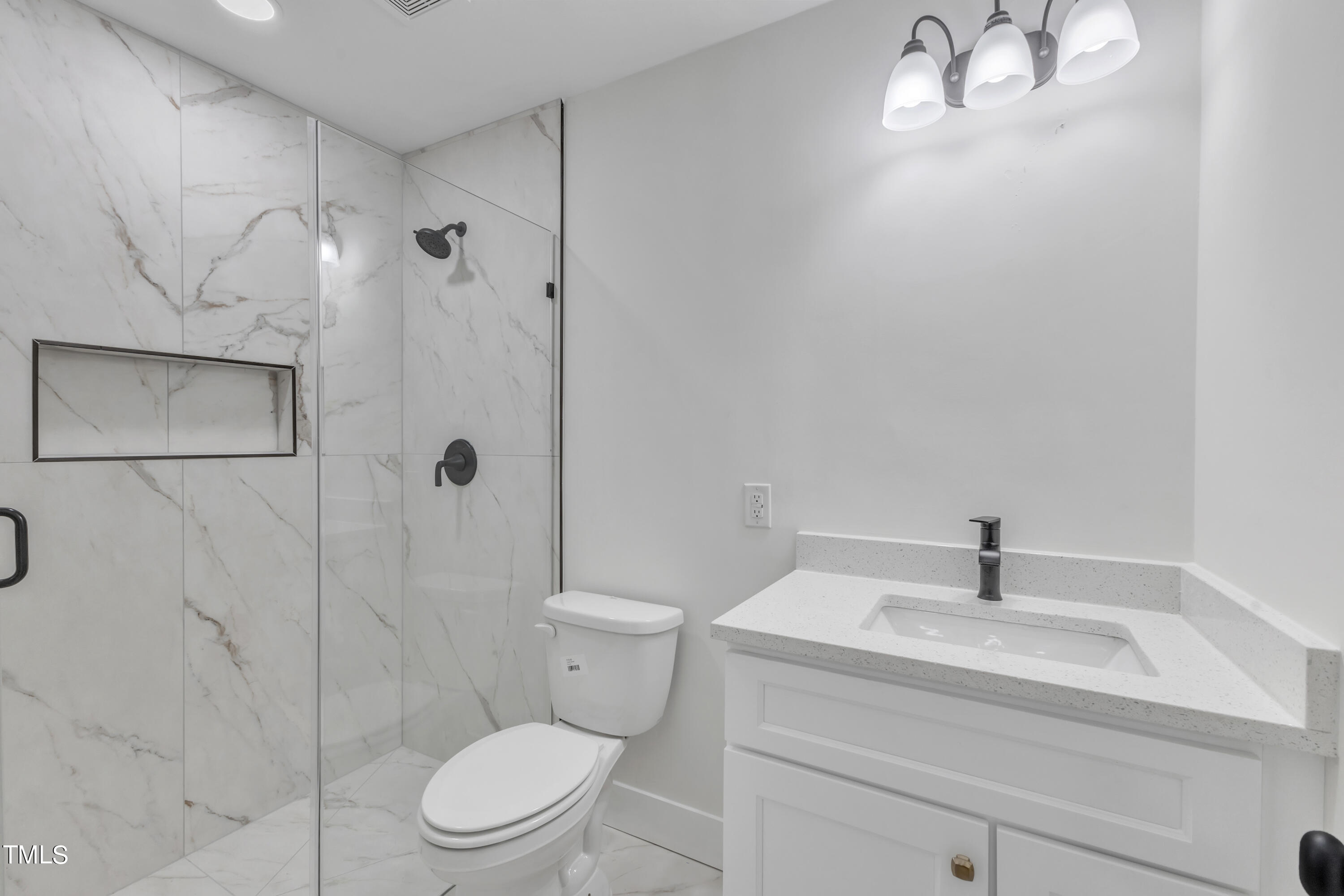 Undisclosed Address Raleigh, NC 27615 - Photo 13 of 26 a bathroom with a sink a toilet and shower