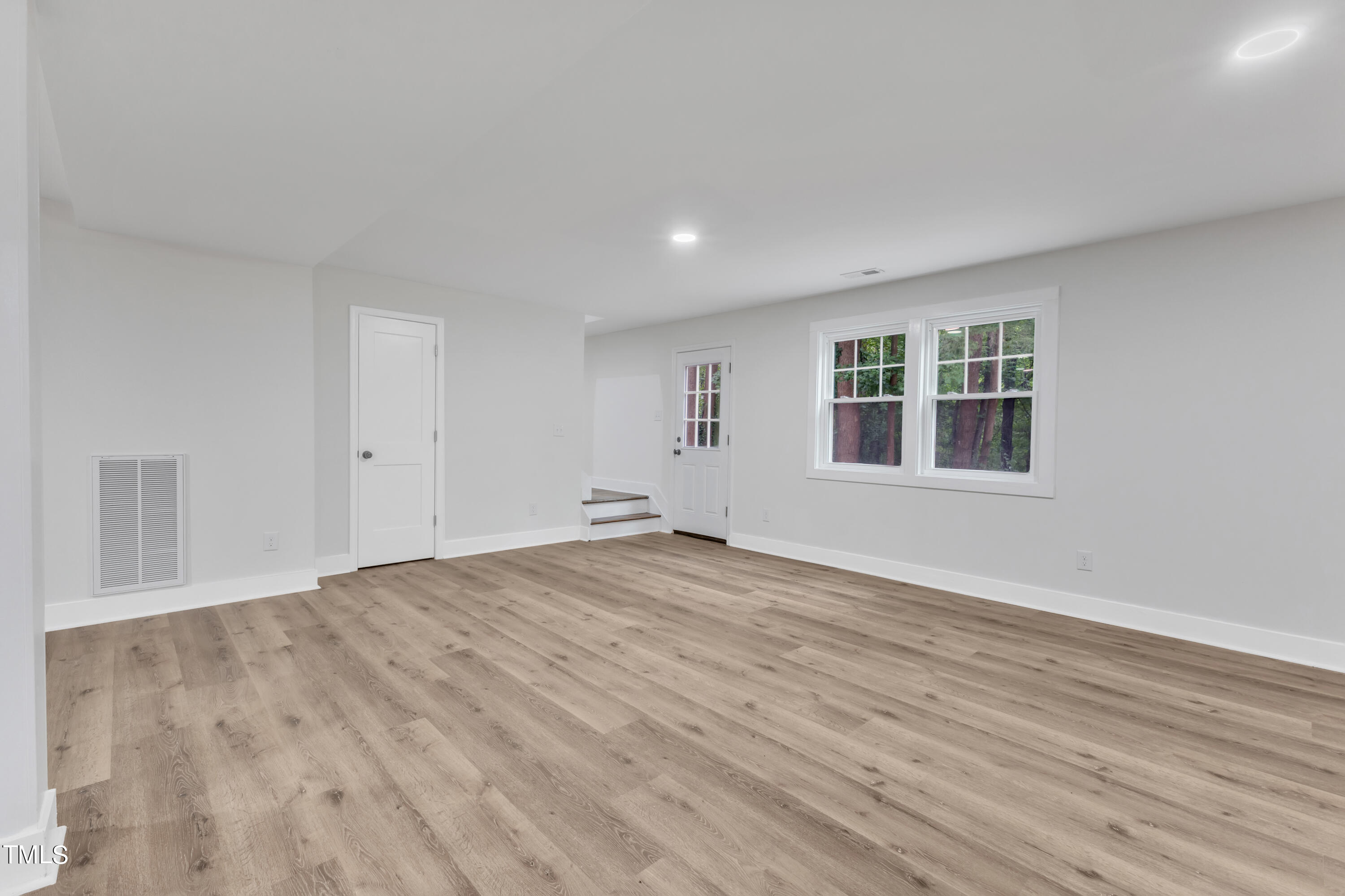 Undisclosed Address Raleigh, NC 27615 - Photo 19 of 26 a view of empty room with wooden floor and fan