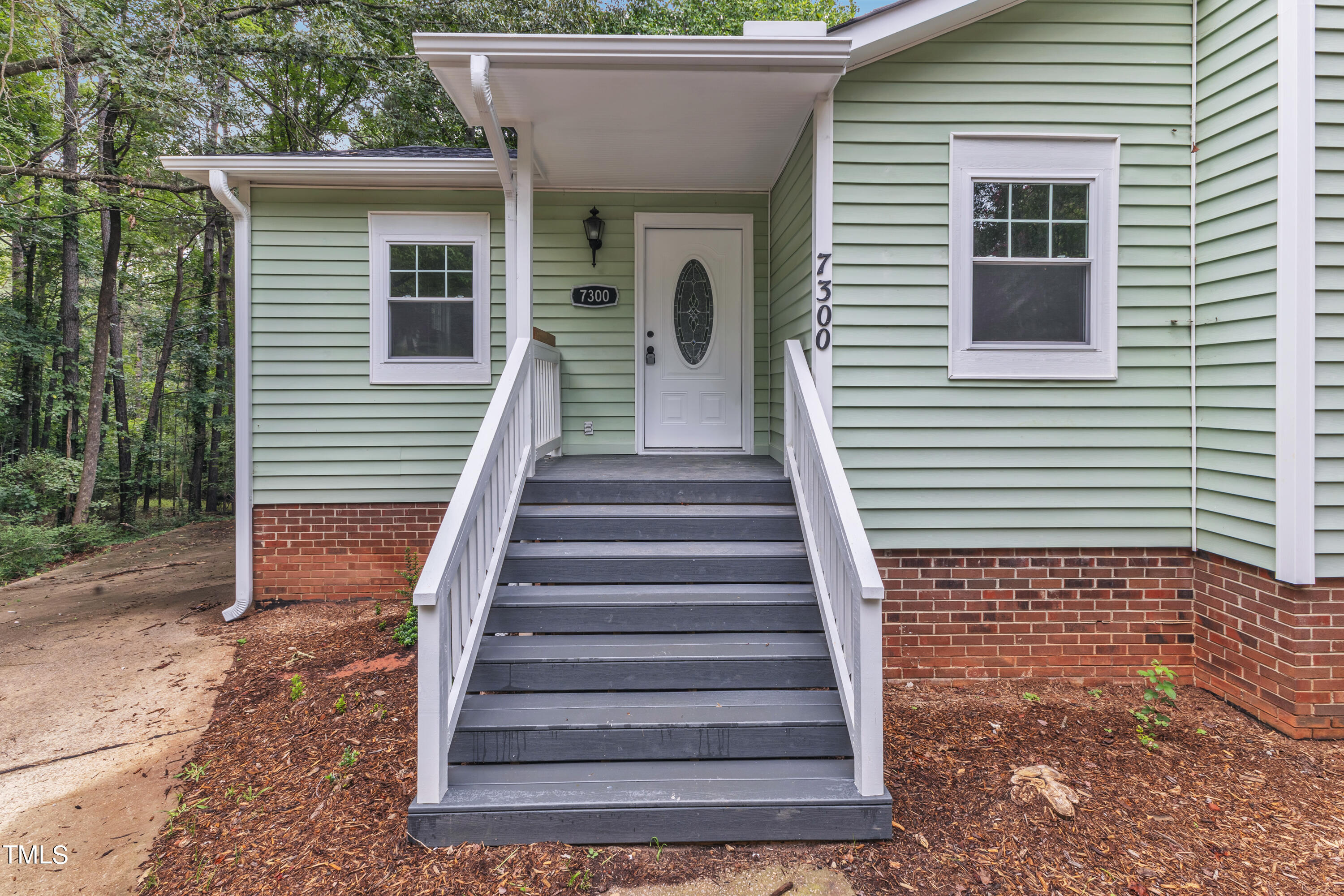 Undisclosed Address Raleigh, NC 27615 - Photo 2 of 26 a view of a house with wooden door and furniture