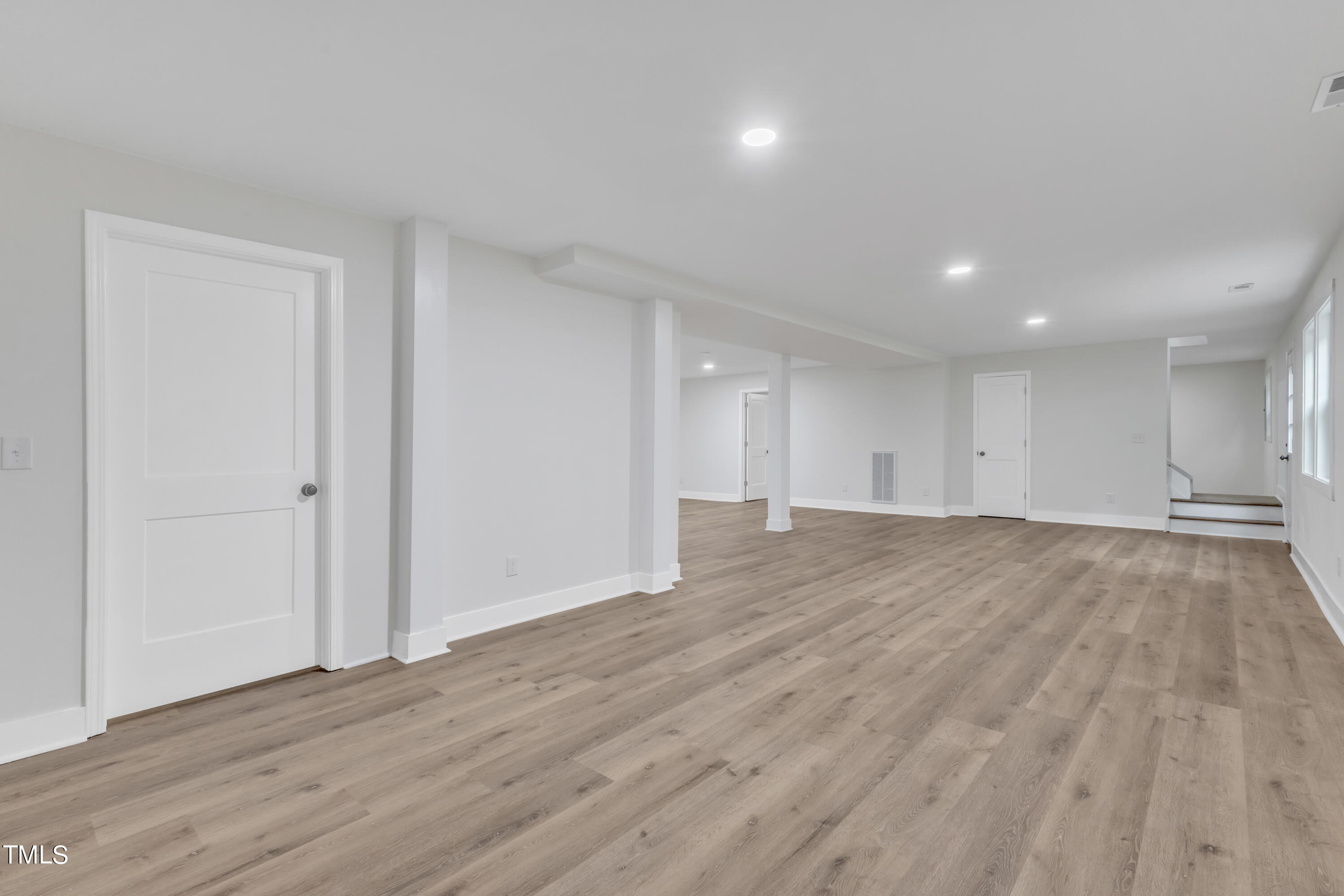 Undisclosed Address Raleigh, NC 27615 - Photo 21 of 26 a view of an empty room with wooden floor