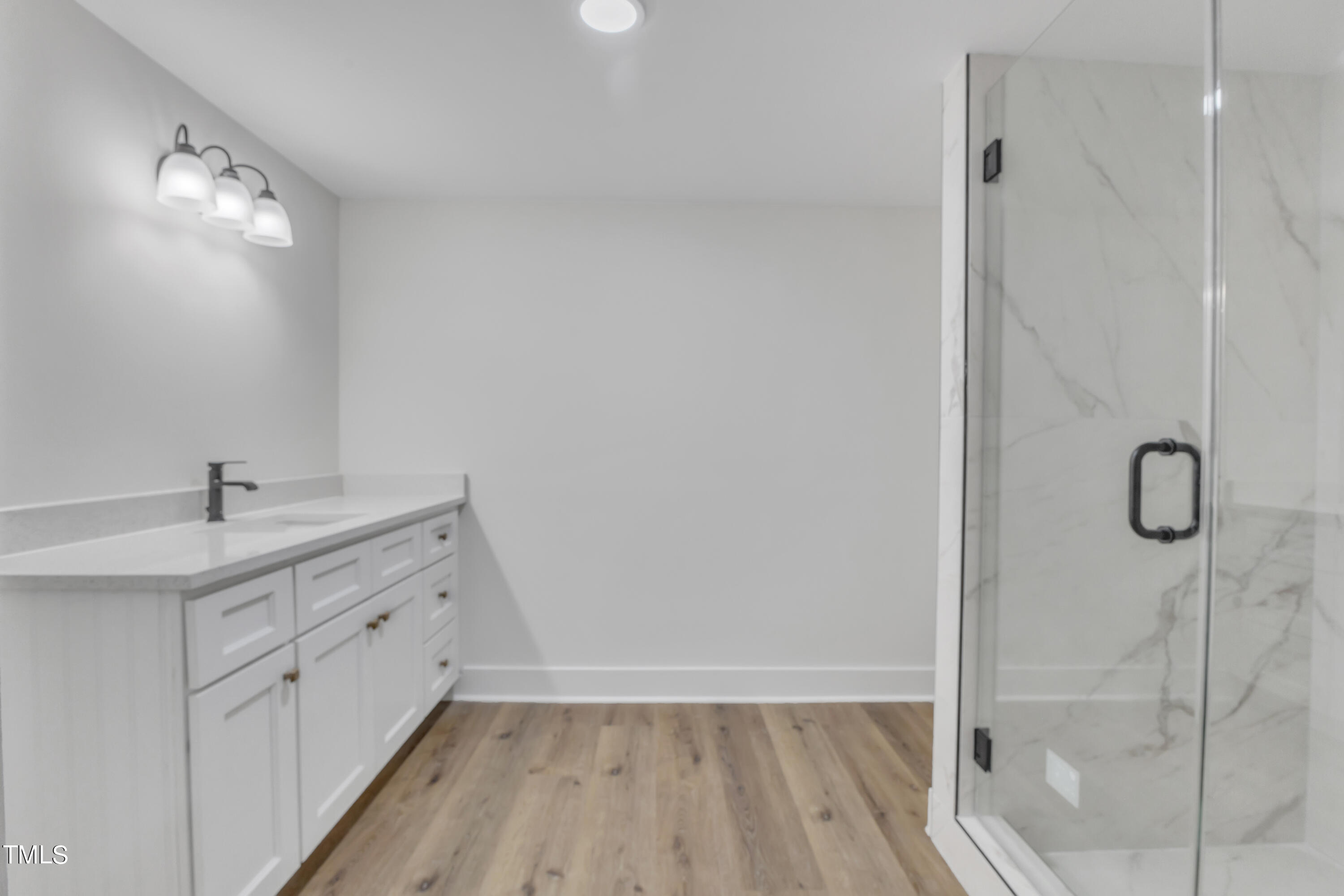 Undisclosed Address Raleigh, NC 27615 - Photo 24 of 26 a bathroom with a double vanity sink and mirror