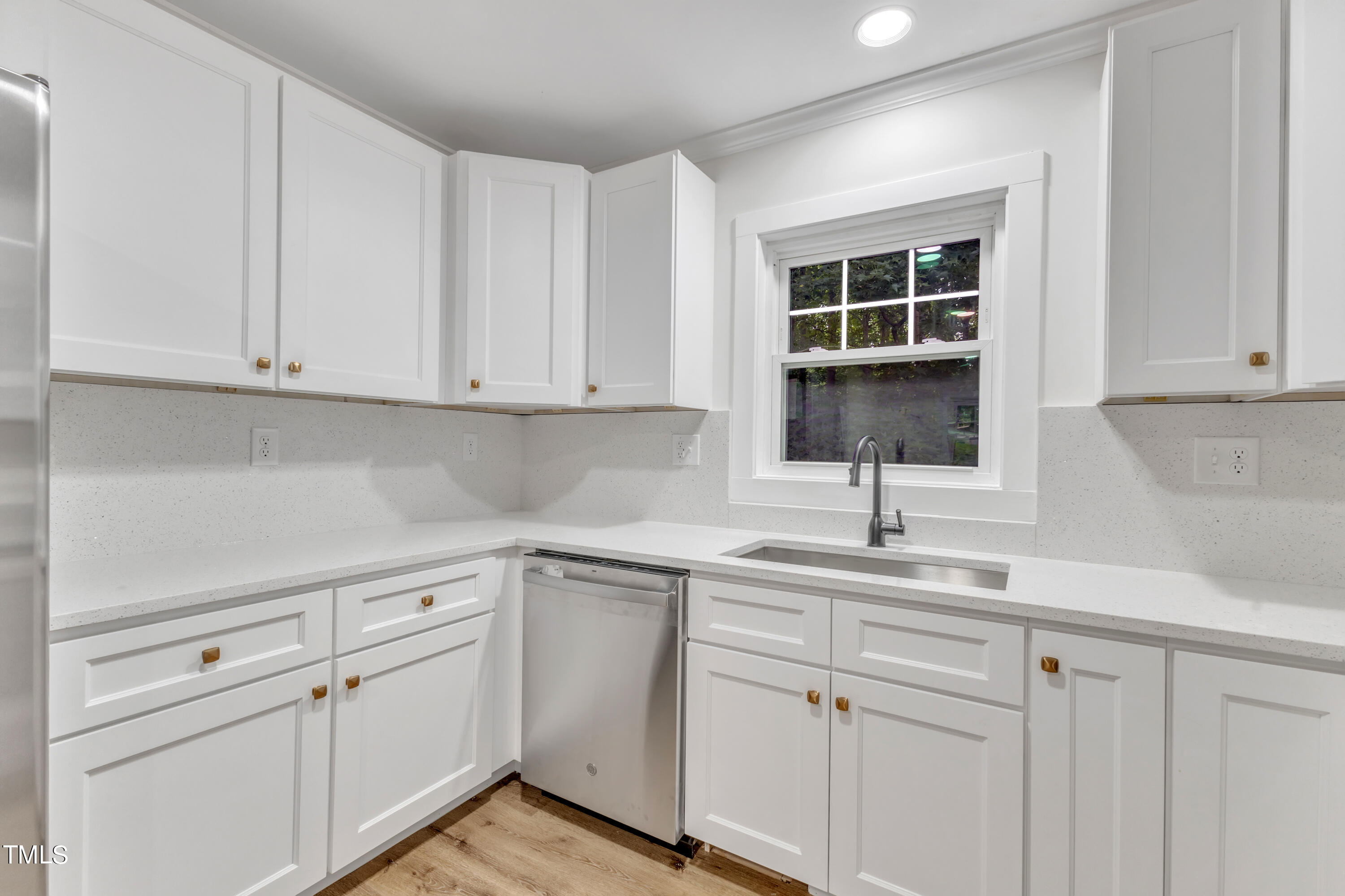 Undisclosed Address Raleigh, NC 27615 - Photo 5 of 26 a kitchen with white cabinets and white appliances