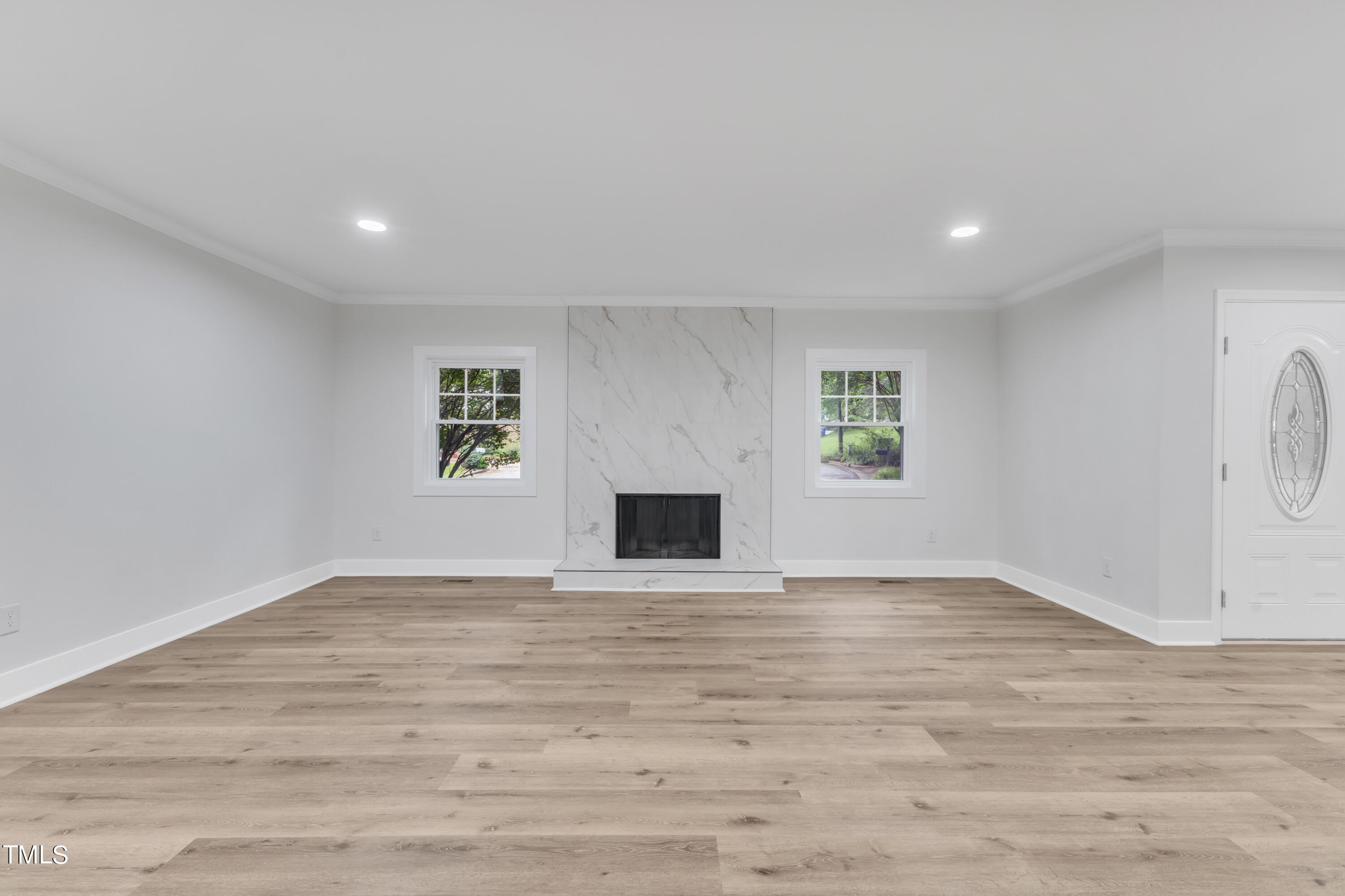 Undisclosed Address Raleigh, NC 27615 - Photo 7 of 26 a view of an empty room with a fireplace and a window