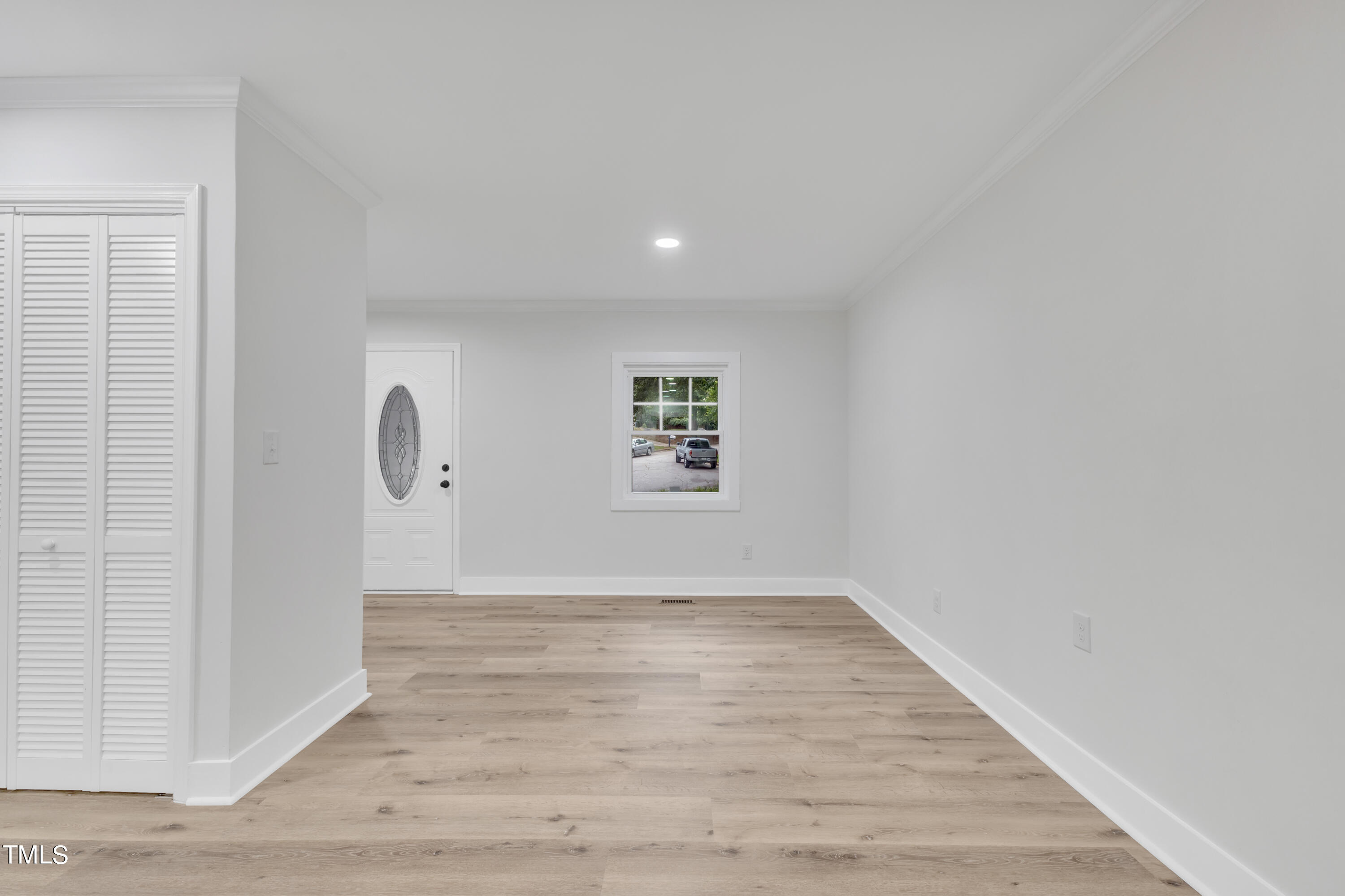 Undisclosed Address Raleigh, NC 27615 - Photo 9 of 26 a view of an empty room with wooden floor and a window