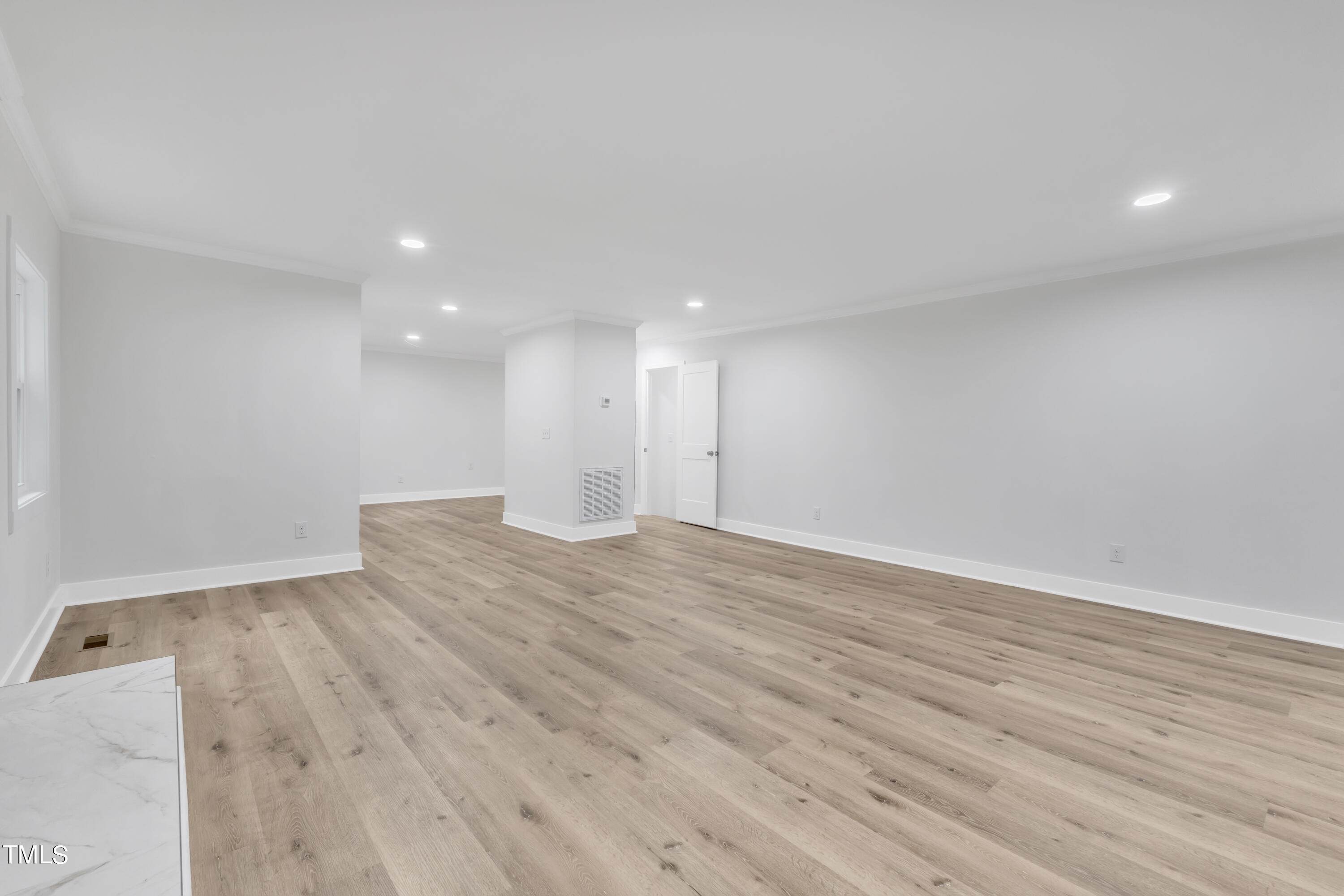 Undisclosed Address Raleigh, NC 27615 - Photo 10 of 26 a view of an empty room with wooden floor