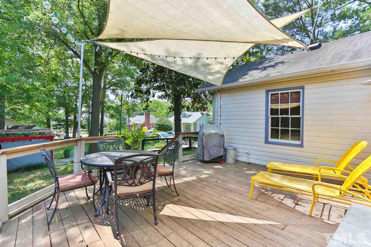 300 East Whitaker Mill Road Raleigh, NC 27608 - Photo 19 of 25 a view of a patio with a table and chairs under an umbrella