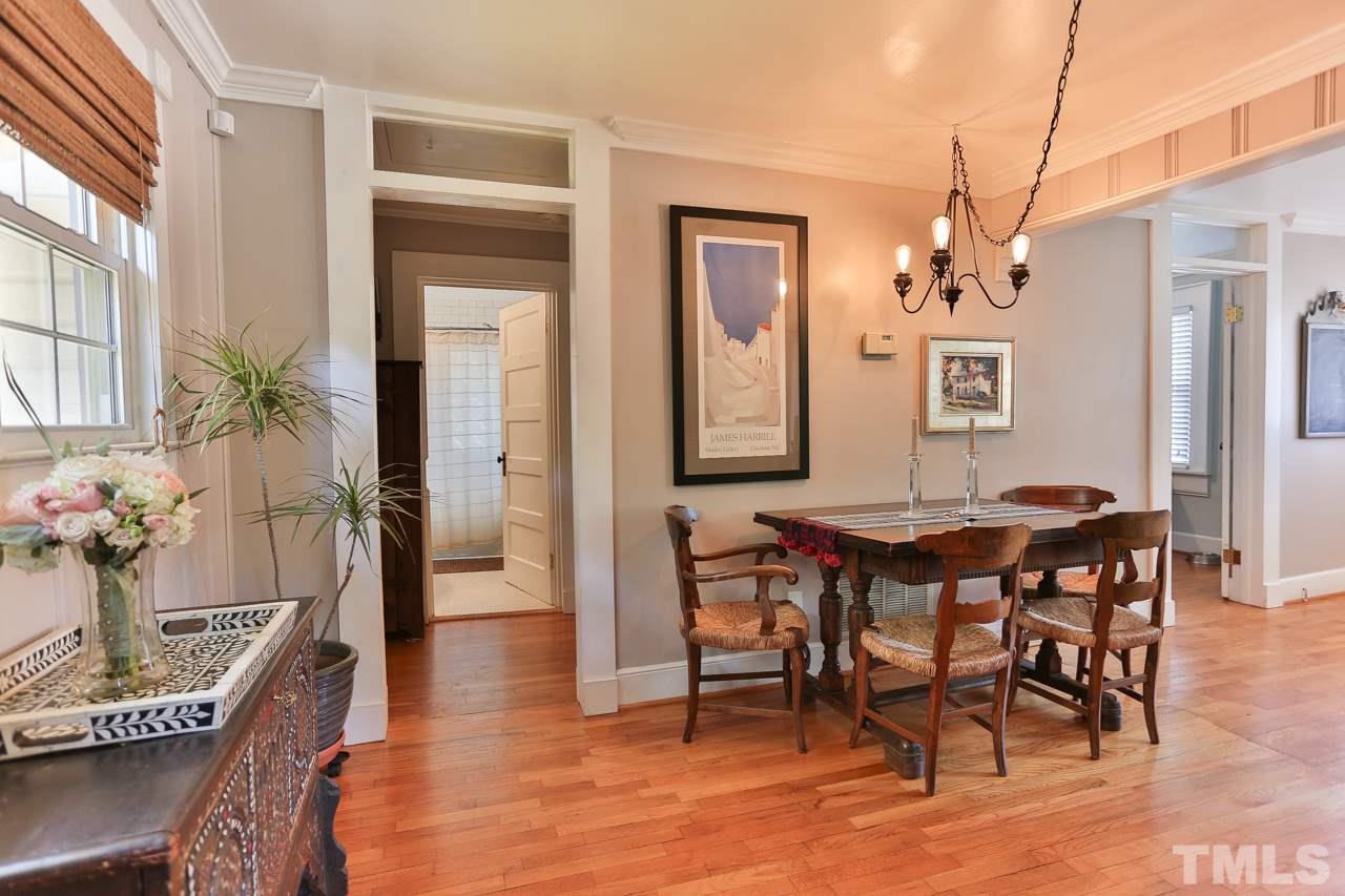 300 East Whitaker Mill Road Raleigh, NC 27608 - Photo 7 of 25 a view of a dining room with furniture and wooden floor