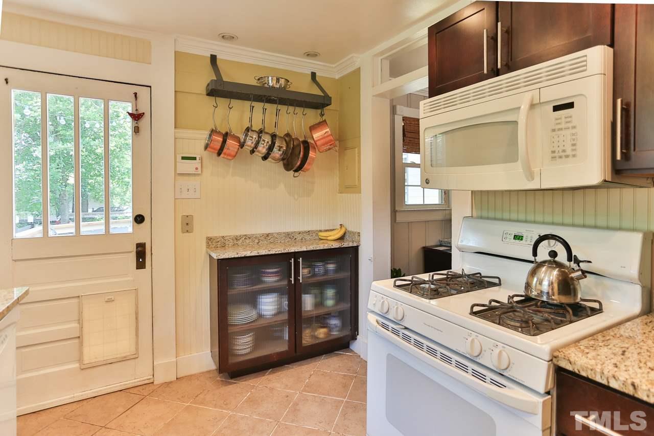 300 East Whitaker Mill Road Raleigh, NC 27608 - Photo 10 of 25 a kitchen with a stove and a microwave