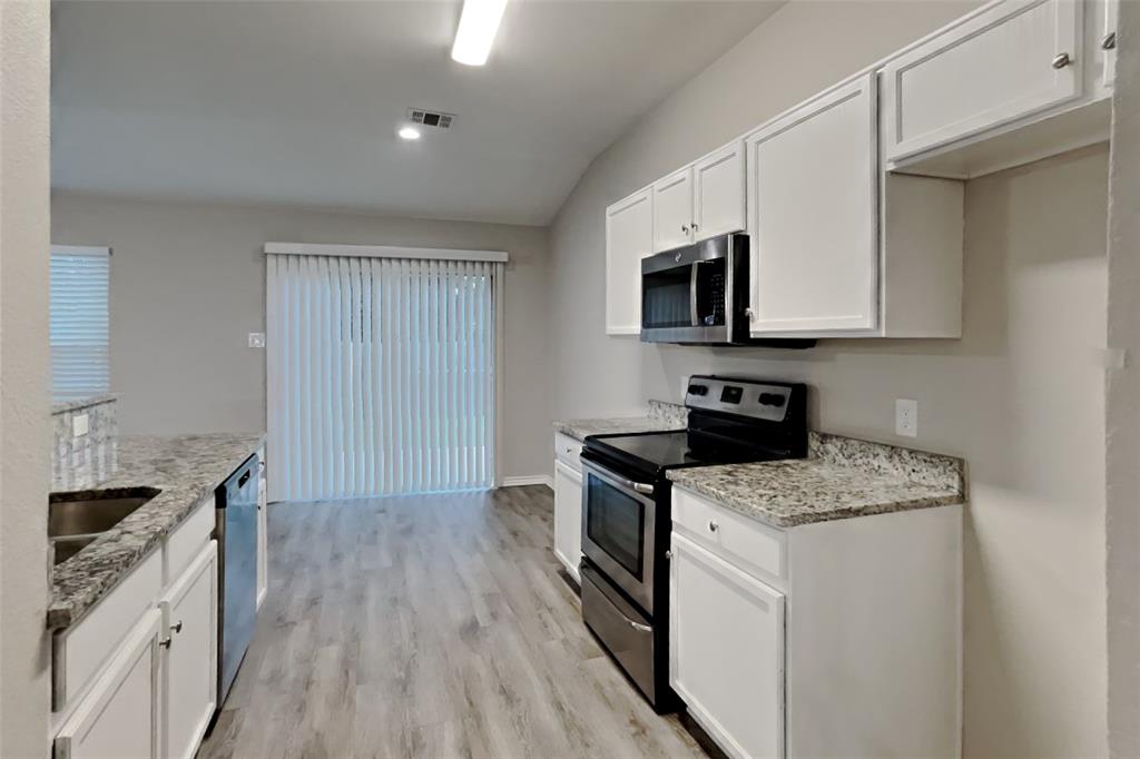 105 Independence Trail Forney, TX 75126 - Photo 5 of 18 a kitchen with a stove sink and microwave
