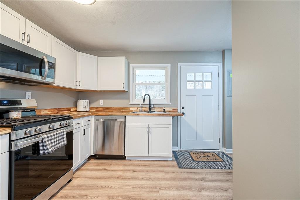 110 Neville Road Beaver, PA 15009 - Photo 7 of 22 a kitchen with stainless steel appliances granite countertop a stove a sink and a microwave