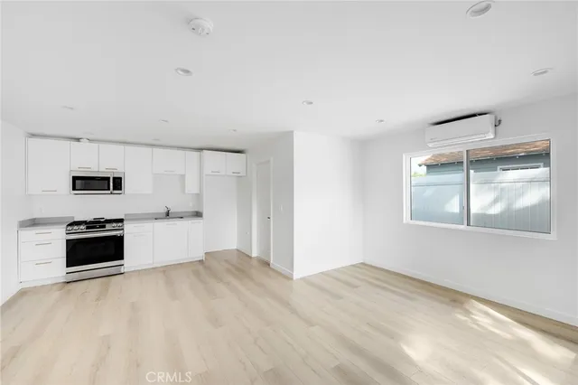 a view of a kitchen with microwave and stove top oven