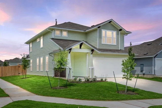 a front view of a house with a garden and plants
