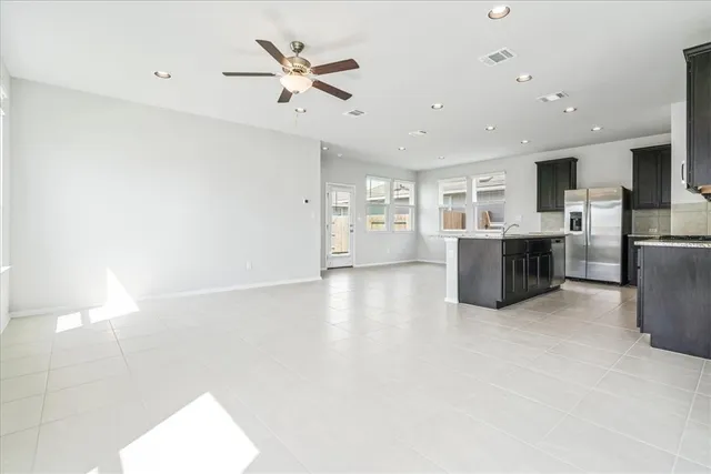 a view of a kitchen with furniture and a ceiling fan