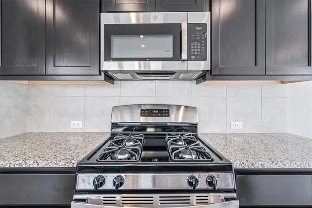 a stove top oven sitting inside of a kitchen