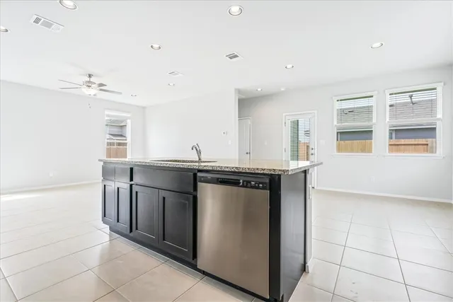 a kitchen with stainless steel appliances granite countertop a sink and a stove