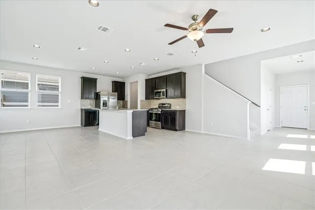 a view of kitchen with refrigerator and microwave