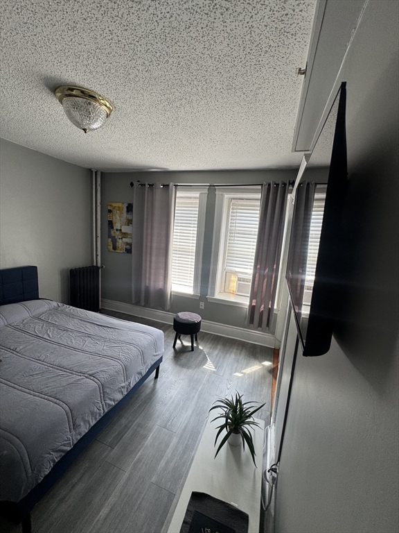 285 Lynn Shore Drive, Unit 203 Lynn, MA 01902 - Photo 12 of 13 a bedroom with a bed and furniture