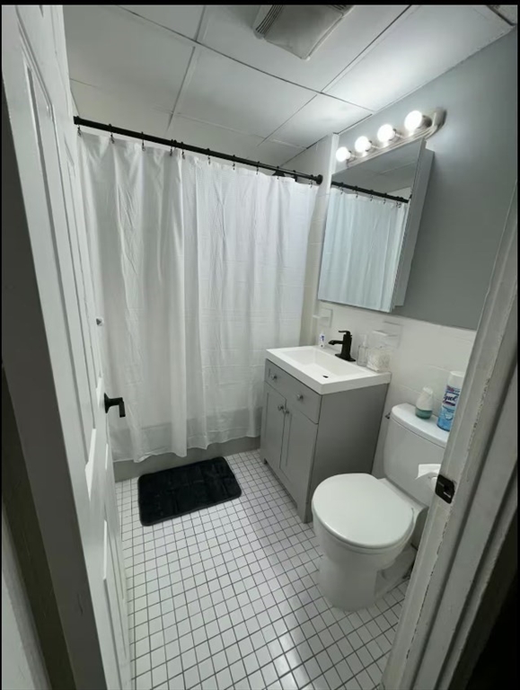 285 Lynn Shore Drive, Unit 203 Lynn, MA 01902 - Photo 13 of 13 a bathroom with a sink a toilet a mirror and shower