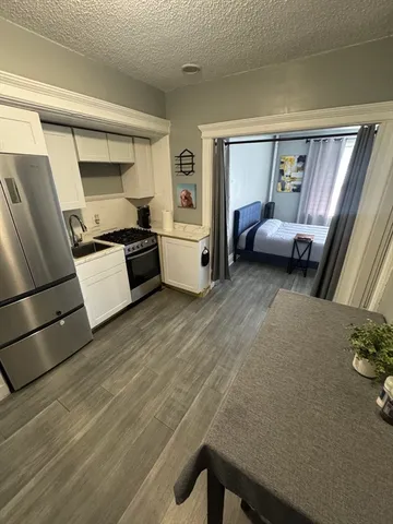 a kitchen with a refrigerator and a stove