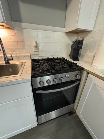 a kitchen with stainless steel appliances a sink stove and refrigerator