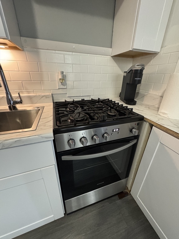 285 Lynn Shore Drive, Unit 203 Lynn, MA 01902 - Photo 5 of 13 a stove top oven sitting inside of a kitchen