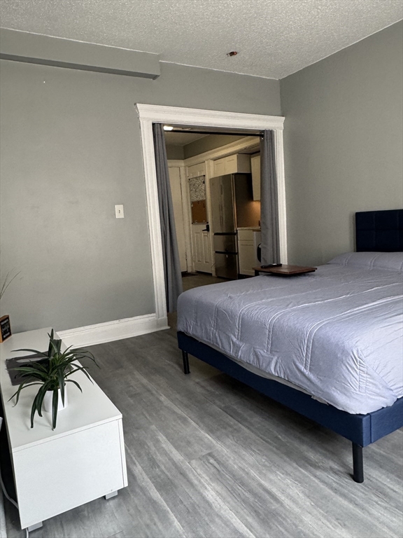 285 Lynn Shore Drive, Unit 203 Lynn, MA 01902 - Photo 9 of 13 a bedroom with a bed and a potted plant