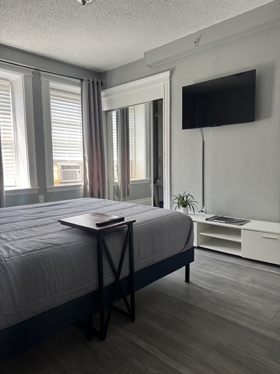 285 Lynn Shore Drive, Unit 203 Lynn, MA 01902 - Photo 10 of 13 a bedroom with a bed and a flat screen tv