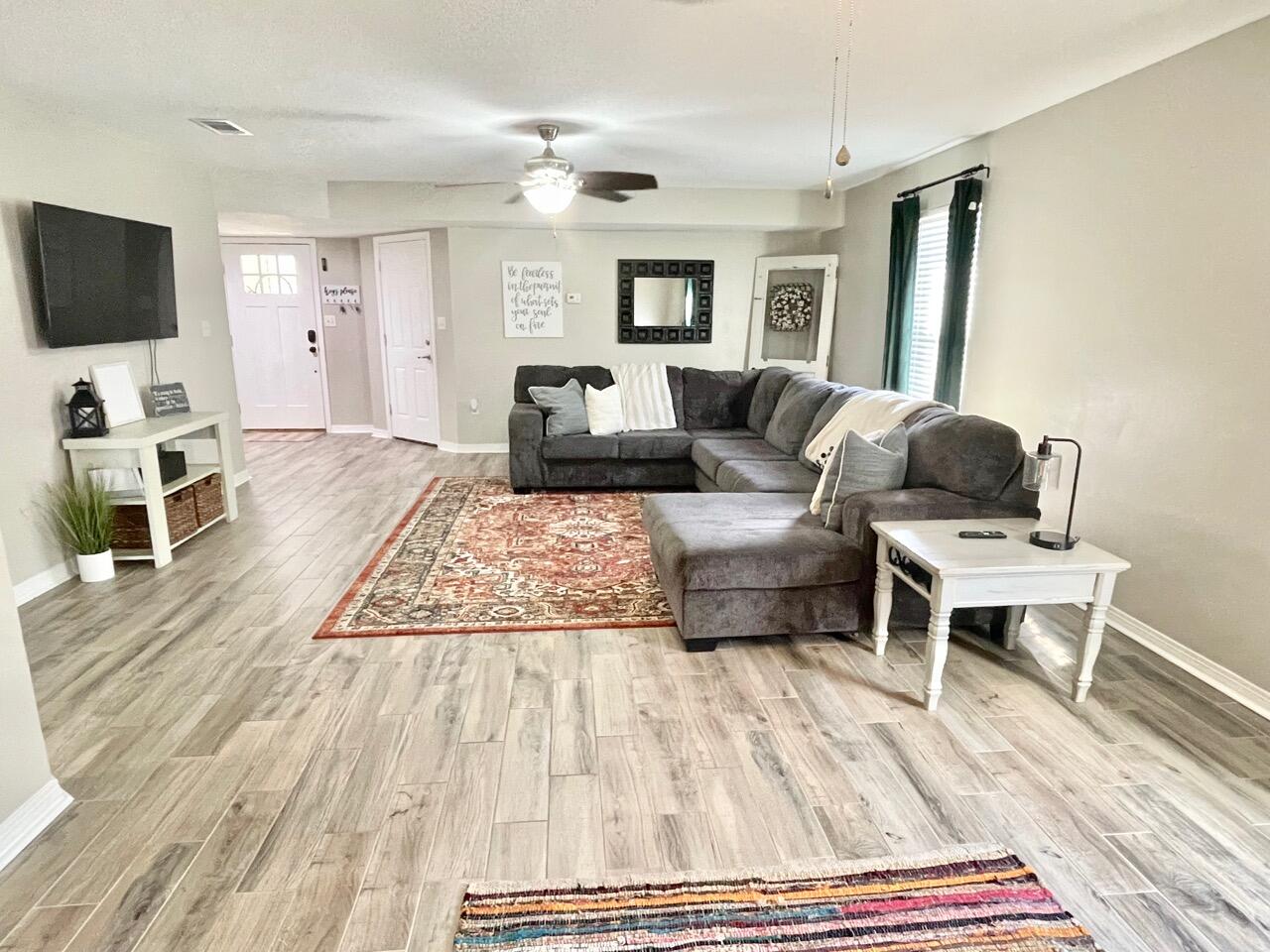 115 Palmetto Drive Crestview, FL 32539 - Photo 11 of 27 a living room with furniture and a flat screen tv