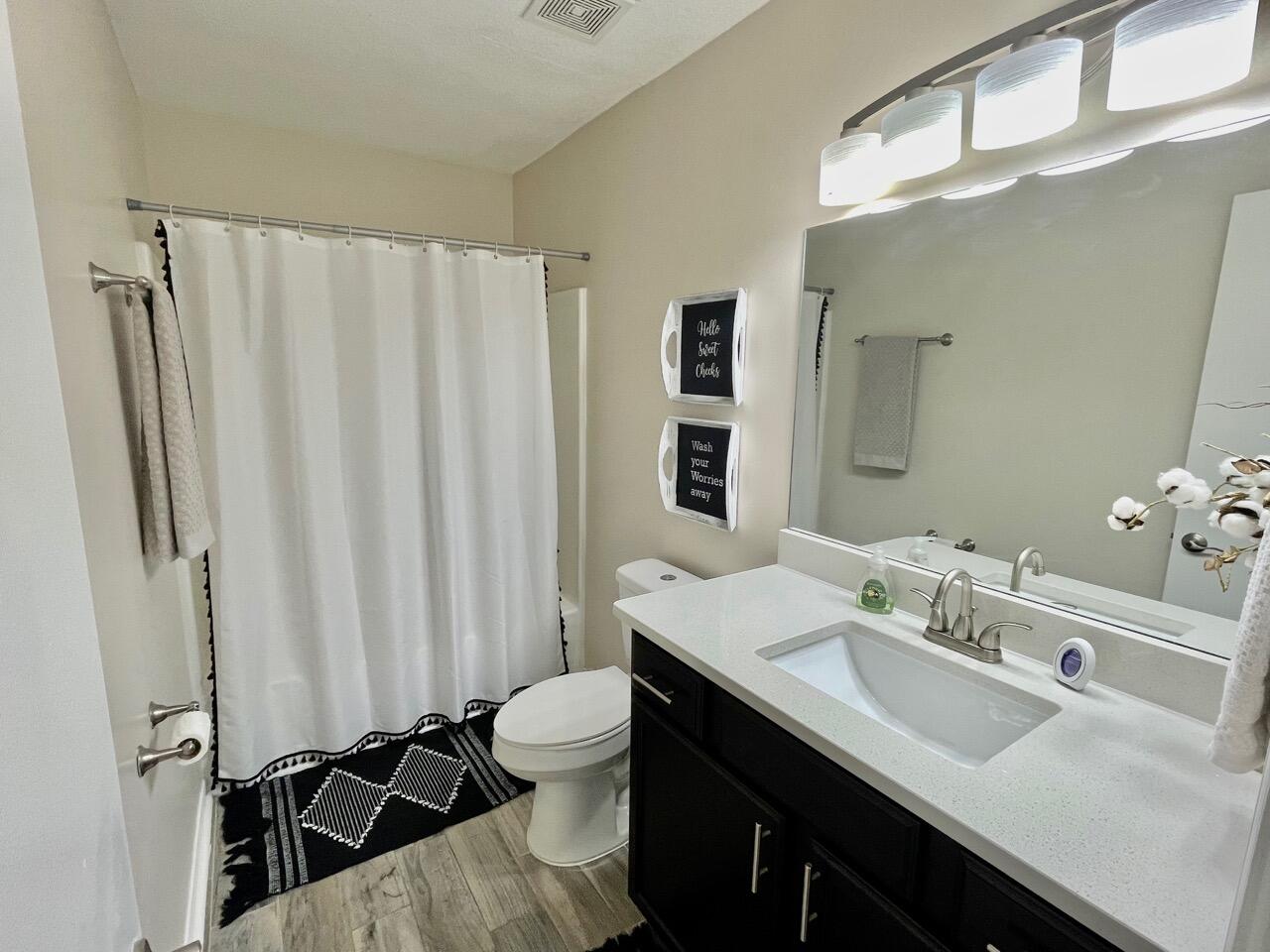 115 Palmetto Drive Crestview, FL 32539 - Photo 14 of 27 a bathroom with a double vanity sink toilet and shower
