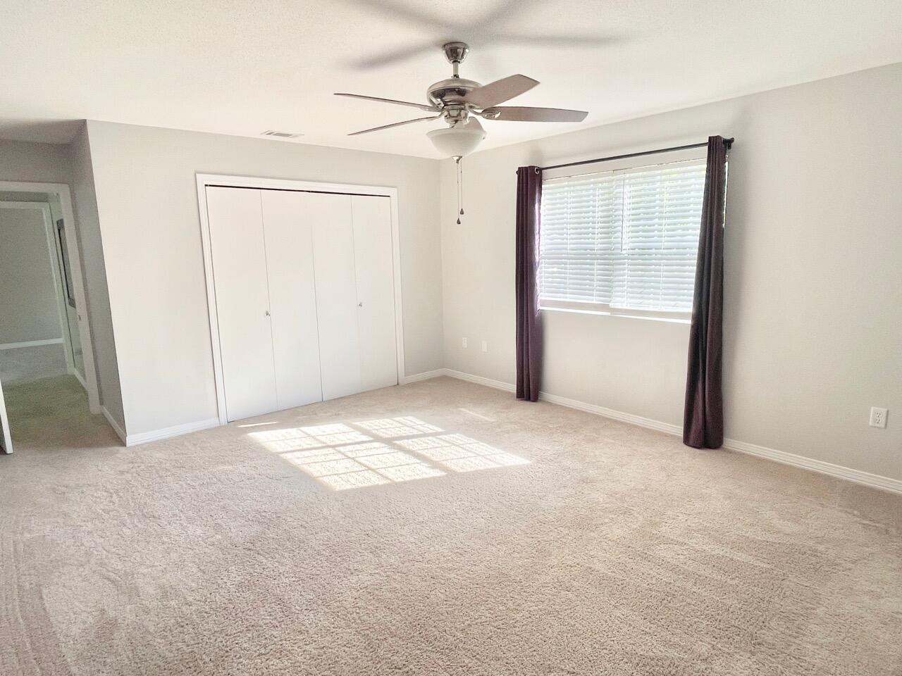 115 Palmetto Drive Crestview, FL 32539 - Photo 17 of 27 an empty room with a ceiling fan and a window