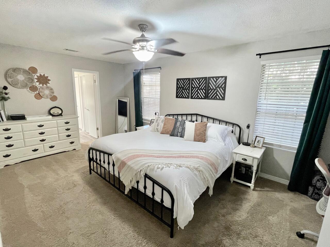 115 Palmetto Drive Crestview, FL 32539 - Photo 19 of 27 a spacious bedroom with a bed and a cabinets