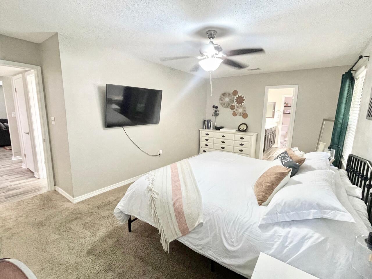 115 Palmetto Drive Crestview, FL 32539 - Photo 20 of 27 a bedroom with a bed and a flat screen tv