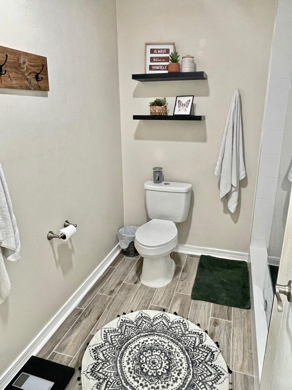 115 Palmetto Drive Crestview, FL 32539 - Photo 22 of 27 a bathroom with a toilet and a shower curtain