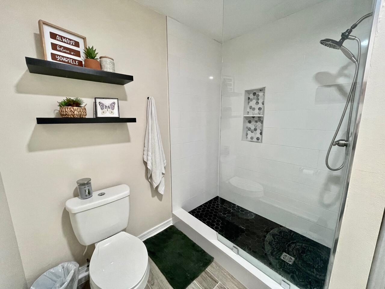 115 Palmetto Drive Crestview, FL 32539 - Photo 23 of 27 a bathroom with a toilet and a shower curtain