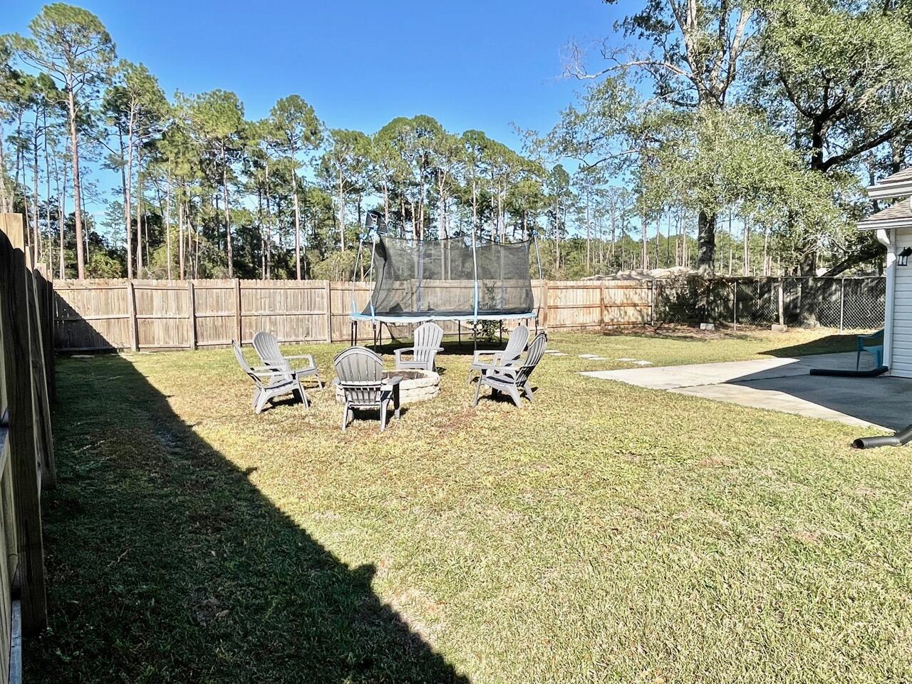115 Palmetto Drive Crestview, FL 32539 - Photo 26 of 27 a view of a yard with table and chairs