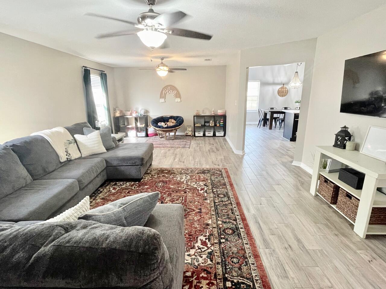 115 Palmetto Drive Crestview, FL 32539 - Photo 5 of 27 a living room with furniture and a flat screen tv