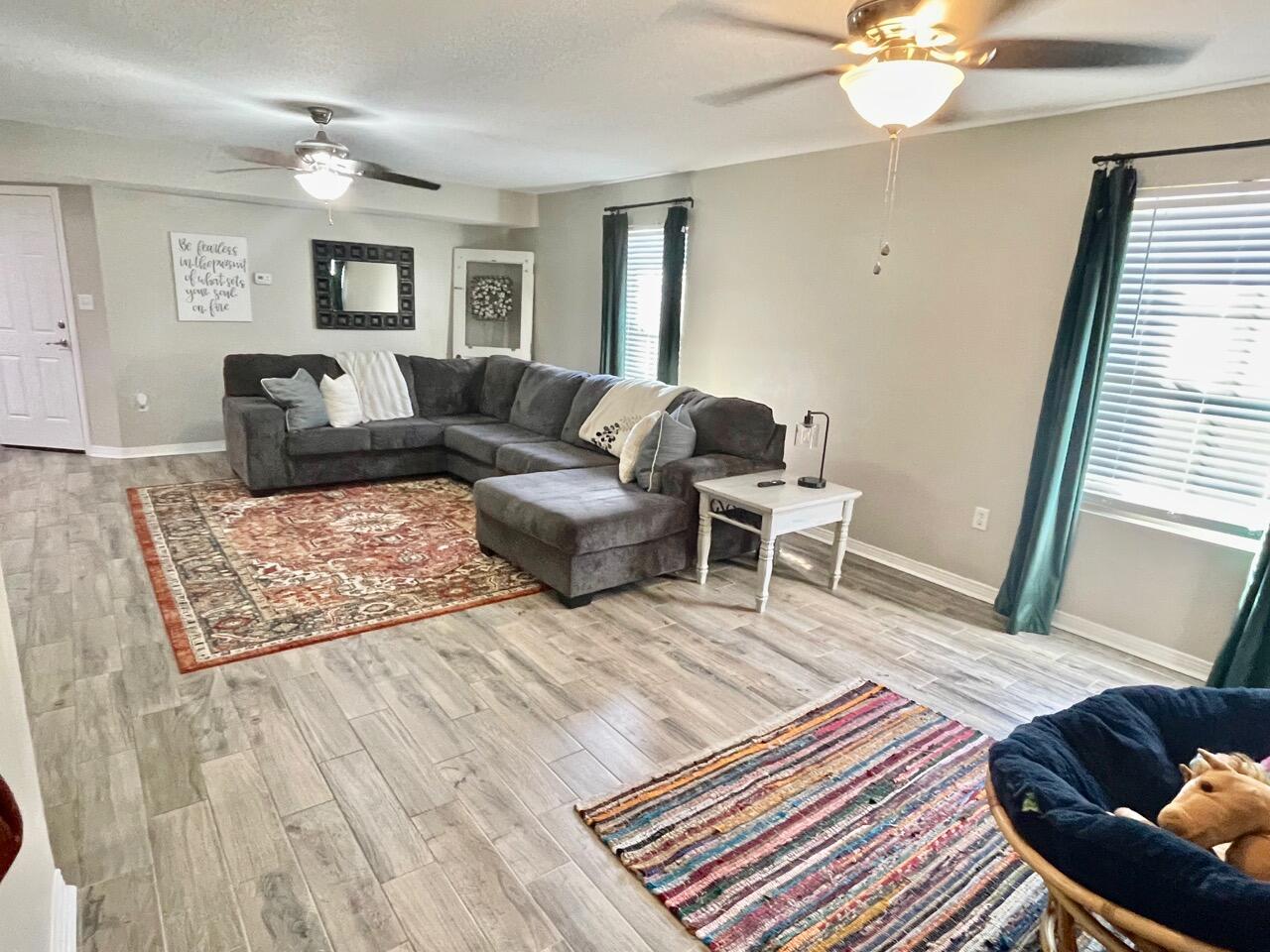 115 Palmetto Drive Crestview, FL 32539 - Photo 10 of 27 a living room with furniture and a rug