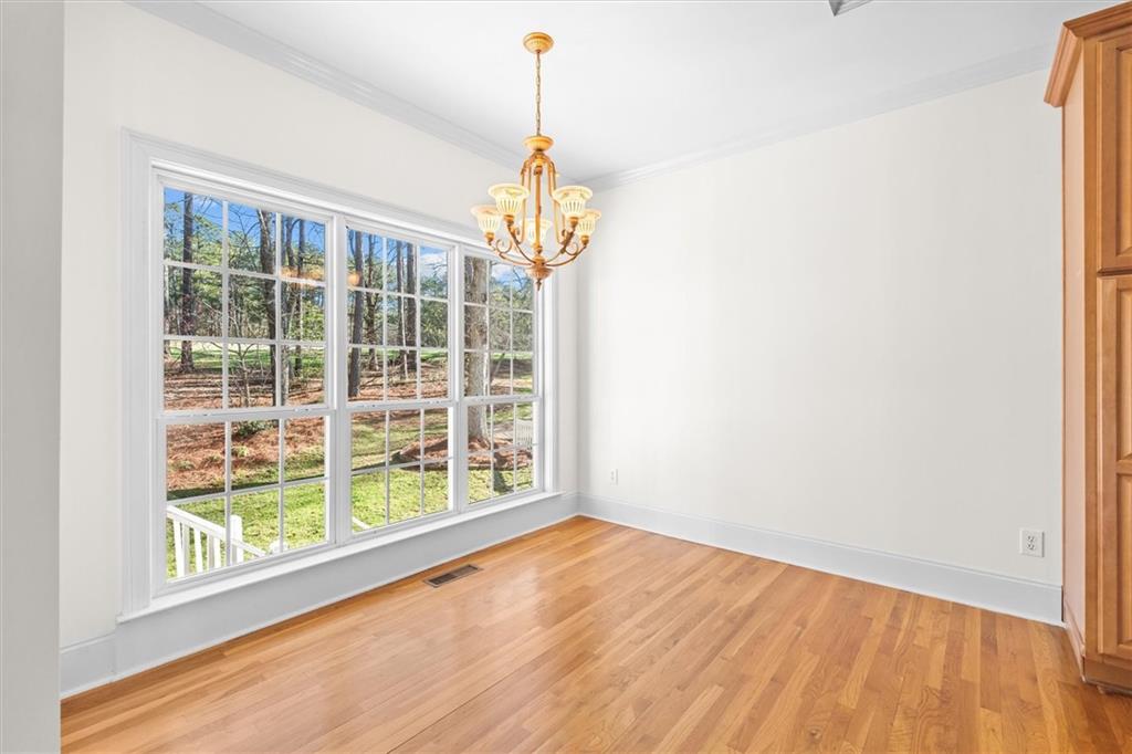 1030 Lakeview Parkway Villa Rica, GA 30180 - Photo 7 of 46 a view of an empty room with wooden floor and a window