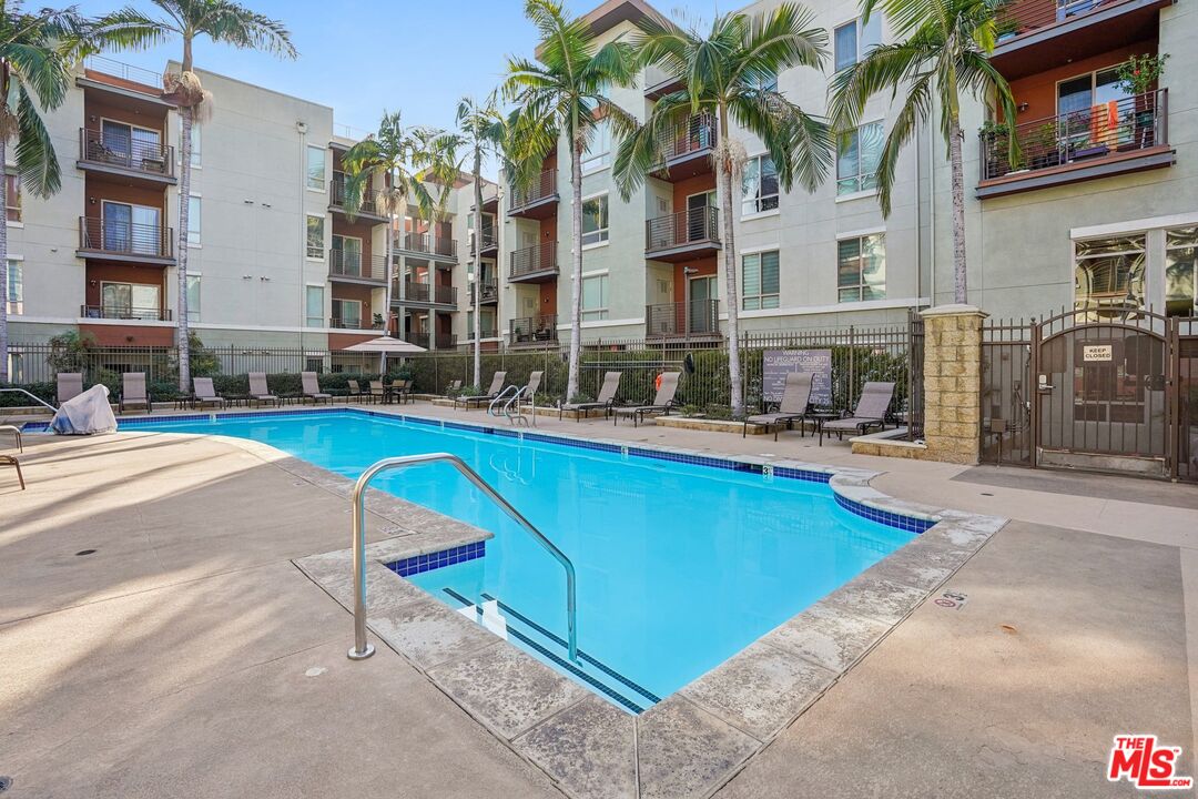 100 South Alameda Street, Unit 346 Los Angeles, CA 90012 - Photo 19 of 24 a swimming pool with outdoor seating and yard