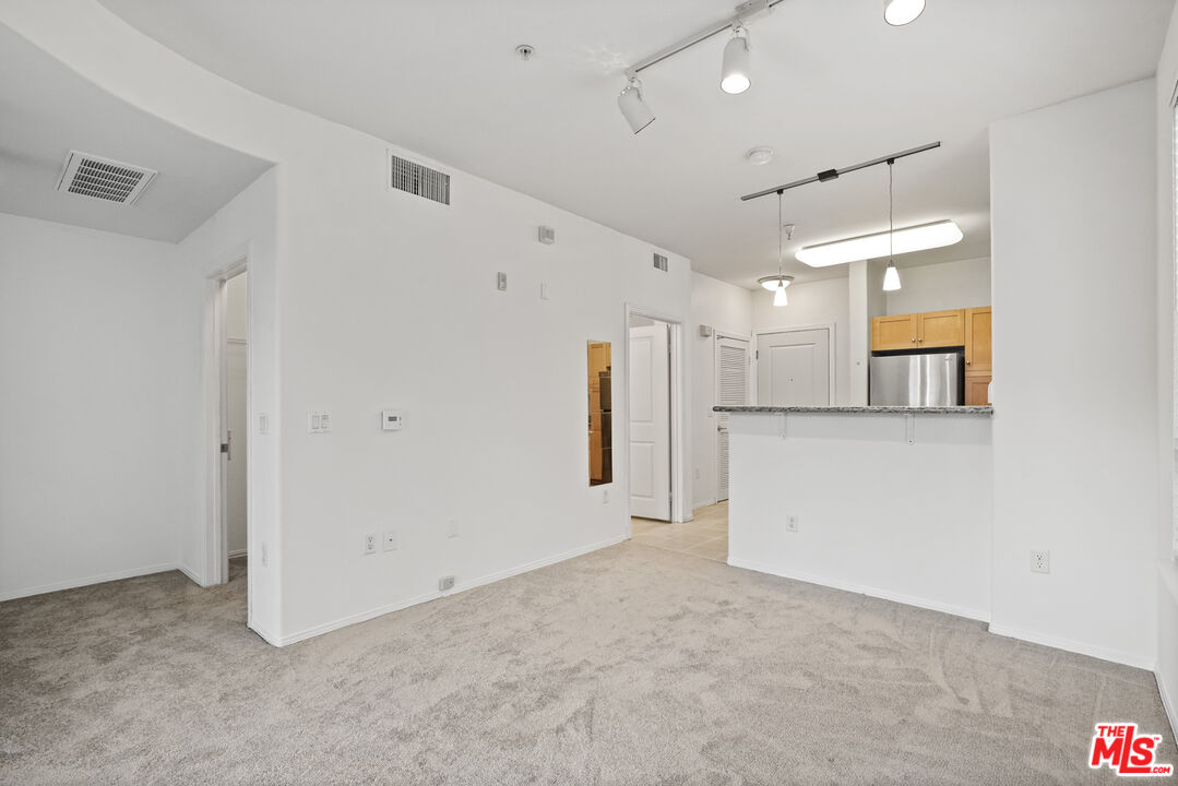 100 South Alameda Street, Unit 346 Los Angeles, CA 90012 - Photo 3 of 24 a view of a kitchen with a refrigerator and a sink