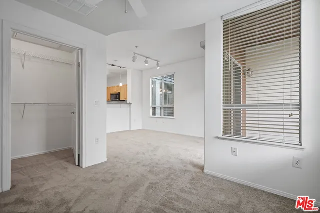 an empty room that has a window in it