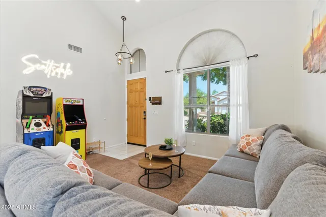 a living room with furniture flowerpot and window