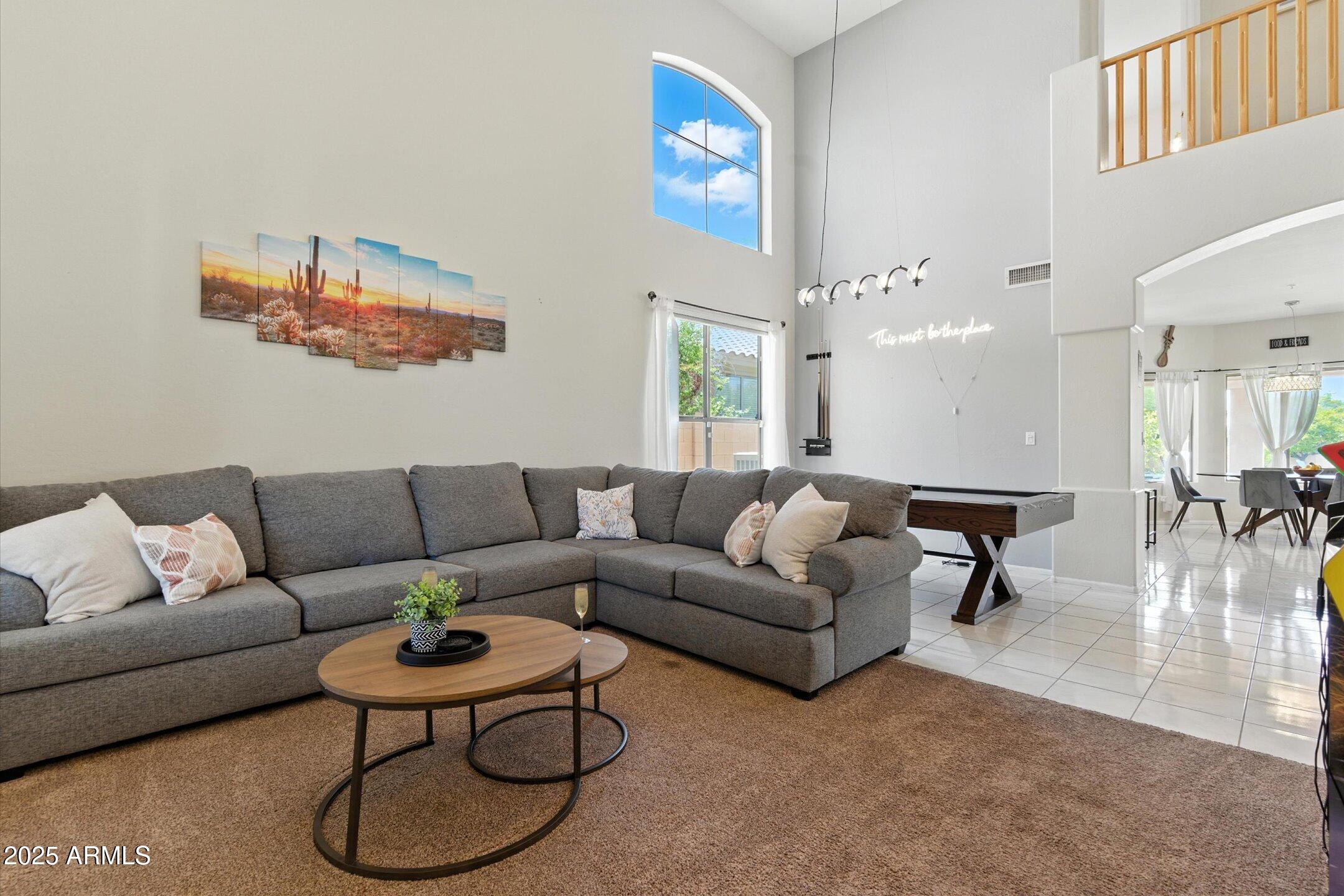 8083 East Michelle Drive Scottsdale, AZ 85255 - Photo 18 of 40 a living room with furniture and a chandelier