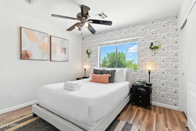 a bedroom with a bed and a chandelier