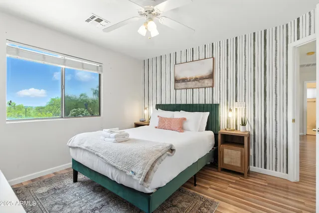 a bedroom with a large bed and a window