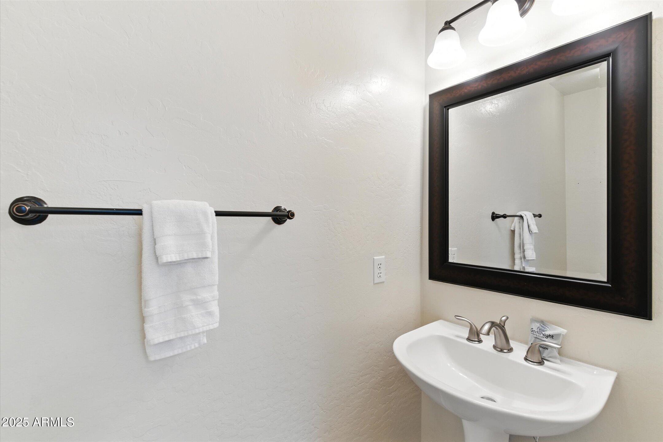 8083 East Michelle Drive Scottsdale, AZ 85255 - Photo 30 of 40 a bathroom with a sink a mirror and a shower