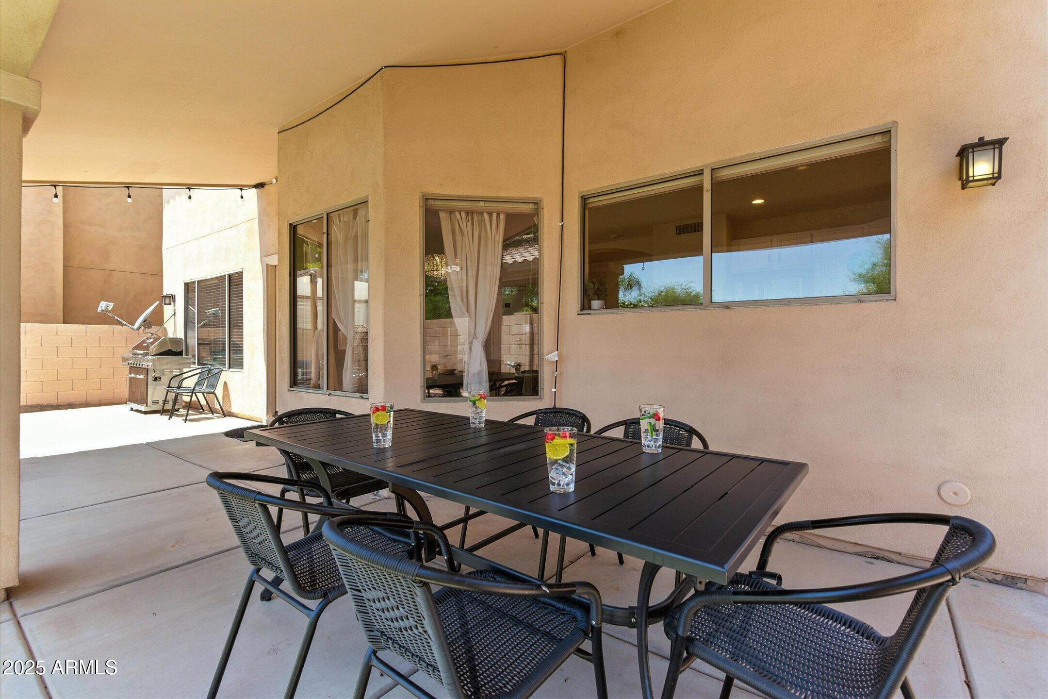 8083 East Michelle Drive Scottsdale, AZ 85255 - Photo 32 of 40 a view of a dining room with furniture and floor to ceiling window