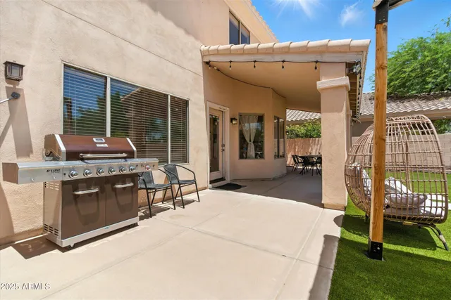 a view of a patio with chairs and a table